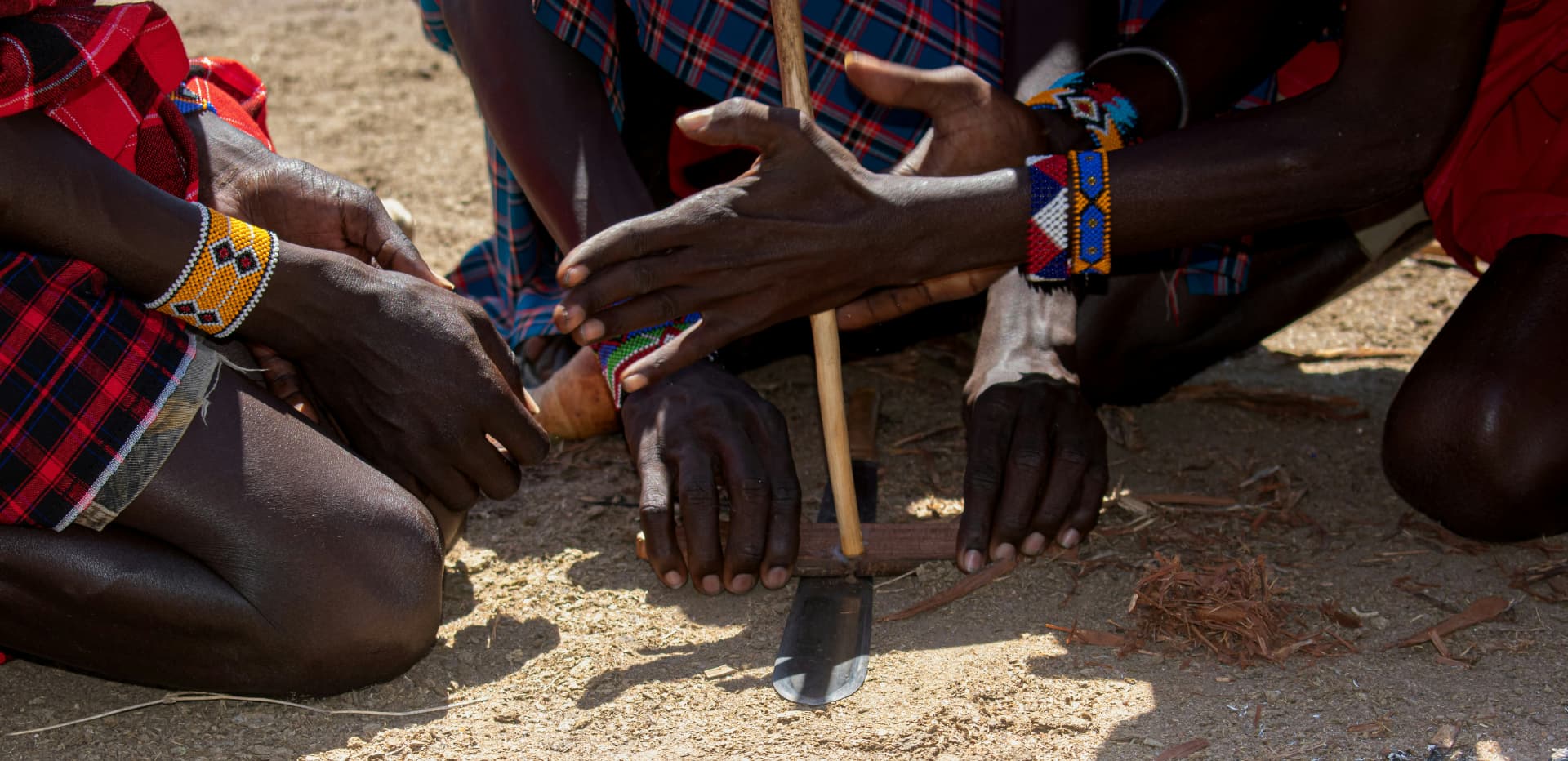 Maasai hands lighting a fire at dusk in the Tanzanian bush